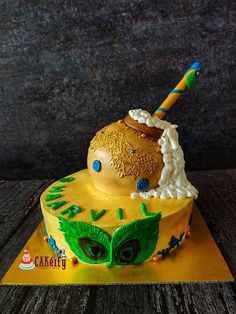 a cake decorated with an owl's eye and a cupcake in the middle