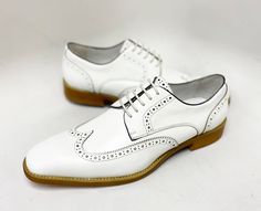 Style: 509-43-White Extremely comfortable, this Exquisite new lace-up Wingtip Blucher Oxford from our Maurice collection in Hand Burnished Leather features a Wingtip Design, Decorative Perforations and Pinking Detail, and a clean, stitched welt! White Plain Toe Lace-up Shoes For Derby, White Lace-up Shoes With Brogue Detailing, Elegant White Wingtip Lace-up Shoes, White Plain Toe Lace-up Business Shoes, White Brogue Lace-up Shoes With Round Toe, White Lace-up Shoes With Perforated Toe Box For Spring, Classic White Lace-up Office Shoes, White Lace-up Formal Shoes For Spring, Formal White Lace-up Shoes For Spring