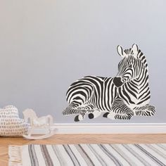 a zebra decal sitting on top of a floor next to a white chair and rug