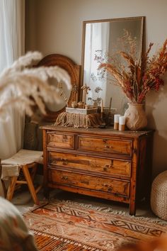 a wooden dresser sitting next to a window with a mirror on top of it's side