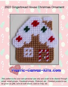 a cross stitch christmas ornament with a gingerbread house in the center and candy canes on top