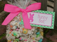 a bag filled with lots of candy sitting on top of a wooden bench next to a sign