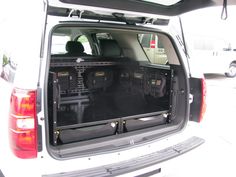 the back end of a white van with its cargo compartment open