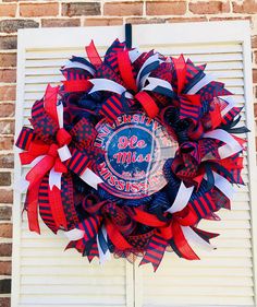 a red, white and blue wreath with the word mississippi on it hanging from a brick wall