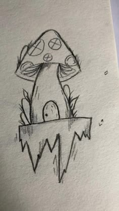 a drawing of a mushroom sitting on top of a piece of paper