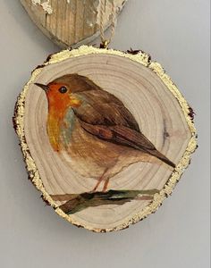 two pieces of wood with birds painted on them