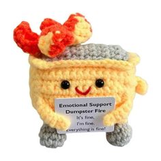 a crocheted stuffed animal with a sign on it's head that says, emotionally support dumpster fire