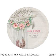 a white plate with pink flowers and feathers on it's rim that says baby shower