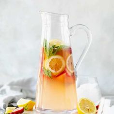 a pitcher filled with lemonade and sliced strawberries