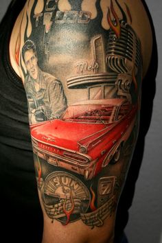 a woman with a tattoo on her arm has a red car in front of it