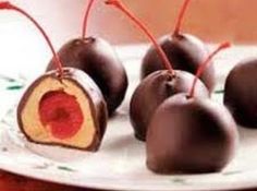 chocolate covered cherries on a white plate