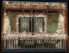 christmas lights decorate the front porch of a house with snowflakes and wreaths