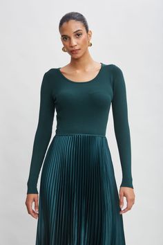 Our effortless Pleated Midi Dress has a distinct modern vibe. The Long Sleeve viscose sweater knit bodice combines with a pleated skirt with graphic handkerchief hem. Definitely poetry in motion! Long Sleeve Knit Bodice Pleated Midi Dress Bodice: 51% Spandex, 32% Viscose, 17% Nylon; Skirt: 98% Polyester, 2% spandex Runs true to Size Model is 5'9" and wearing size S Dry Clean Only Imported Style #: ETR44225 Winter Pleated Long Sleeve Midi Dress, Fitted Long Sleeve Midi Dress With Pleated Hem, Fall A-line Midi Dress With Pleated Sleeves, Pleated Fitted Long Sleeve Midi Dress, Stretch A-line Pleated Midi Dress, Nylon Skirt, Dress Bodice, Handkerchief Hem, Long Sleeve Short Dress