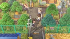 an animal crossing in the middle of a park with two people standing on either side