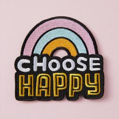 a close up of a patch with the words choose happy in front of a rainbow