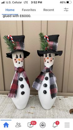 two snowmen with hats and scarfs on their heads are standing next to each other