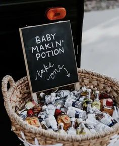 a basket filled with baby makin'potton bottles next to a chalkboard