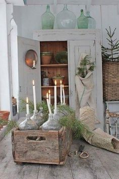 candles are lit in glass bottles on an old wooden crate