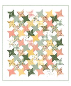 an image of a quilt with stars on the front and back, in pastel colors