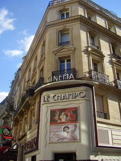 a tall building with an advertisement on the side of it's front window and balconies