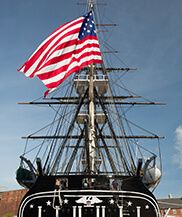 a large boat with an american flag on it's mast