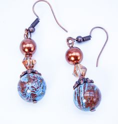 "Cynthia Lynn \"SIENNA CANYON\" Blue and Brown Calsilica Copper Pearl Drop Earrings features 12mm calsilica beads with copper bead caps, 8mm copper pearl and bicone copper crystal. Look for more pieces not pictured here. 2 inches Includes drawstring gift bag Matching pieces pictured are sold separately" Copper Beaded Earrings With Round Beads, Blue Copper Round Bead Jewelry, Blue Copper Round Beads Jewelry, Blue Round Bead Copper Jewelry, Blue Hypoallergenic Copper Earrings, Artisan Jewelry Earrings, Drawstring Gift Bag, Copper Crystal, Copper Pearl