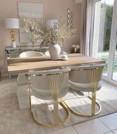 a dining room table with chairs and vases on it