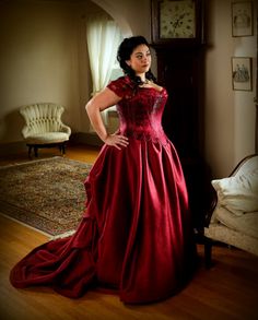 a woman in a red dress posing for the camera