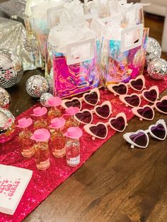 the table is set up with heart shaped sunglasses and other items for valentine's day