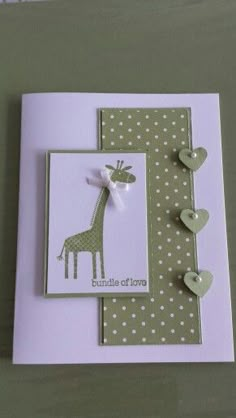 a card with a giraffe and hearts on it