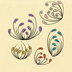 four different colored flowers on a piece of paper with some writing underneath the flower petals