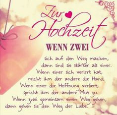 a pink heart hanging from a string with words written in german and english on it