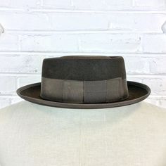 "Size 6 7/8 Vintage 1950s 1960s Adam Hats Carbon Brown Porkpie Fedora Hat For your consideration we have a vintage fedora from the '50s/'60s. Made by Adam Hats from a \"carbon brown\" fur felt, this \"Rugby\" model features a telescopic crown, brown grosgrain band and edge, leather sweatband, and rayon lining. There are a few spots on the hat band and a few stitches have come out of the leather sweatband. This is still a great hat and wonderful for anyone into slick bop midcentury style. Measure Midcentury Style, Green Cap, Model Features, Brown Fur, Hat Band, Philadelphia Pa, Fedora Hat, Hat Sizes, Vintage 1950s