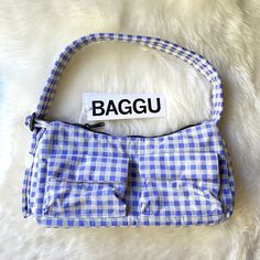 New With Tag. Color: Blue Gingham A Baguette Style Purse With Two External Flap Pockets For Easy Access To Your Essentials. - Two Exterior Flap Pockets With Magnetic Closure - Measures 4.7" H 11" W 3" D - Adjustable 29.5" Quilted Strap - Recycled Heavyweight Nylon With Recycled Ripstop Lining - Machine Washable ** First Time On Poshmark? Use Code Emmmamercer When You Create Your Poshmark Account To Receive A $10 Credit Toward Your First Purchase. ** Blue Rectangular Picnic Bags, Blue Tote Bag For Picnic, Daily Use Gingham Square Shoulder Bag, Daily Use Square Gingham Shoulder Bag, Rectangular Gingham Shoulder Bag For Everyday, Everyday Rectangular Gingham Shoulder Bag, Gingham Pouch Bag For Daily Use, Trendy Gingham Travel Bags, Everyday Gingham Shoulder Bag