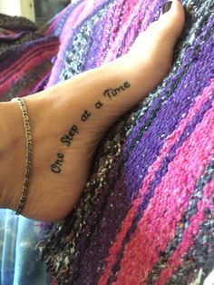 a person with a foot tattoo saying, once at a time