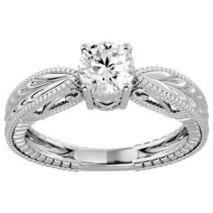 a white gold engagement ring with an intricate design