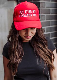 You'll be wearing this trucker hat on repeat! Our newest red trucker hat is a funny nudge at all the wonderful hubby's out there! Red trucker hat White "Put it on my husband's tab" embroidered on the front Adjustable snapback closure Breathable mesh on the back Designed in the U.S.A. Produced in China. Red Trucker Hat With Letter Print, Fun Red Trucker Hat With Letter Print, Red Trucker Snapback Hat, Red Letter Print Snapback Trucker Hat, Fun Red Trucker Hat, Red Snapback Trucker Hat, Novelty Red Trucker Hat, Red Trucker Hat One Size Fits Most, Novelty Red Baseball Cap One Size