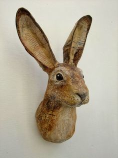 a brown rabbit head mounted to the side of a wall