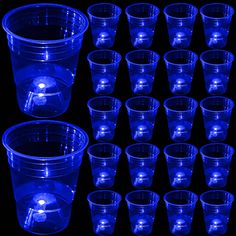 blue plastic cups are arranged in rows on a black background, with the lids slightly down