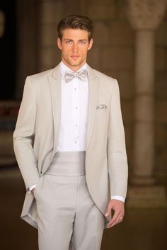 a man in a tuxedo and bow tie on the catwalk at a fashion show