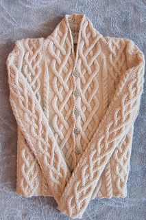 the sweater is knitted and ready to be worn on someone's bed or couch