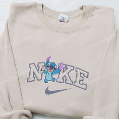 Introducing the Stitch Ice Cream x Nike Cartoon Embroidered Sweatshirt, a unique collaboration that combines the beloved character Stitch with Nike’s iconic style. This hoodie features intricate embroidery of Stitch enjoying a delicious ice cream treat, adding a playful touch to your wardrobe. The Nike-inspired design of this sweatshirt showcases a modern and trendy aesthetic, [...] Nike Cartoon, Disney Character Shirts, Nike Inspired, Embroidered Apparel, Embroidered Shirts, Stitch Cartoon, Nike Pullover, Shirt Nike, Hoodie Material