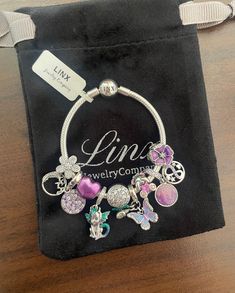 the charm bracelet is on display in a bag