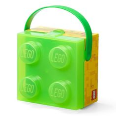 a green lego lunch box with four pieces in it