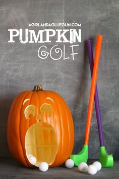 an orange pumpkin sitting next to two golf balls and a purple mallet with the word pumpkin golf written on it