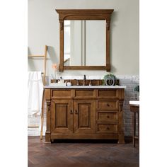 a bathroom vanity with a large mirror above it and wooden cabinetry on the side