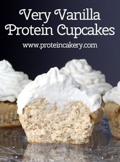 very vanilla protein cupcakes with white frosting on a clear glass platter