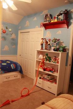 a child's bedroom with toys on the shelves