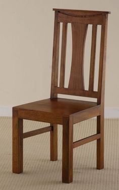 a wooden chair sitting on top of a carpeted floor