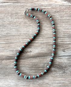 A lightweight beaded mens necklace made with wood, jasper and turquoise blue magnesite beads. - Length measures 21.5" (more lengths are available)- 8mm beads- Heavy duty beading wire- Gunmetal lobster claw clasp (more types are available) The length may vary slightly due to the clasp chosen and the nature of the coconut beads.The mannequin's neck size is 14.5". Our jewelry is not waterproof.All DLD 4 Men jewelry comes in a brown kraft paper jewelry box for gift giving. We use the highest quality Mens Necklaces, Mens Beaded Necklaces, Pearl Statement Necklace, Mens Necklace, 8mm Beads, Bracelets Design, Beads Bracelet Design, Long Beaded Necklace, Bracelet Design